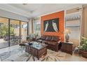 Cozy living room featuring a leather sofa, area rug, and lots of natural light at 10612 Glencorse Ter, Bradenton, FL 34211