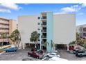Exterior of a building with parking spots and trees at 12924 Gulf Blvd # 502, Madeira Beach, FL 33708