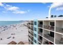 Exterior view of a multi-story building with balconies overlooking the beach at 12924 Gulf Blvd # 502, Madeira Beach, FL 33708
