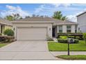 A charming single-story home boasts a two-car garage, well-maintained landscaping and mature flowering bushes at 12934 Tikal Way, Trinity, FL 34655
