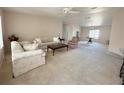Spacious living room with neutral carpet, comfortable seating, and ample natural light at 131 E Saint Annes Cir, Apollo Beach, FL 33572