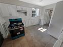 Galley style kitchen featuring white cabinets and a stainless steel oven at 1715 Delaware Ne Ave, St Petersburg, FL 33703