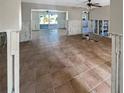 Spacious living room featuring tiled floors and sliding glass doors to the outdoor pool at 1715 Delaware Ne Ave, St Petersburg, FL 33703