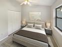 Serene bedroom featuring neutral colors, minimalist decor, and ample natural light from a window at 2011 Arbor Dr, Clearwater, FL 33760