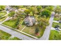 Expansive aerial view showcasing the home, surrounding neighborhood, and mature trees at 22119 Weeks Blvd, Land O Lakes, FL 34639