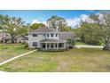 Lovely two-story home with unique architectural details and a well-manicured front lawn at 22119 Weeks Blvd, Land O Lakes, FL 34639
