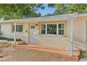 Welcoming front entrance featuring a brick-paved porch and white trim at 230 Davison Ne Ave, St Petersburg, FL 33703