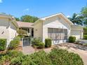 Inviting home exterior with well-manicured landscaping and a charming gated walkway leading to the entrance at 2618 Newcomb Ct # 12, Sun City Center, FL 33573