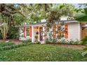 Quaint home exterior featuring orange shutters and well-maintained landscaping for a welcoming ambiance at 2624 W Prospect Rd, Tampa, FL 33629