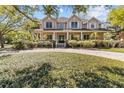 Elegant two-story home with inviting front porch and well-manicured landscaping at 3010 82Nd N Way, St Petersburg, FL 33710