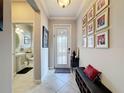 Inviting entryway with decorative tile, decorative glass front door, and charming bench with Gathering photo gallery at 32101 Goddard Dr, Wesley Chapel, FL 33543
