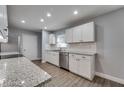 Bright kitchen boasts stainless steel appliances, sleek cabinets, and granite countertops at 3451 Pine St, Dunedin, FL 34698