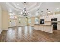 Bright and airy living space with tiled floors, modern chandelier, and an open layout to the kitchen at 4205 57Th N Ave, St Petersburg, FL 33714