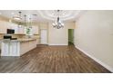 Open floor plan featuring kitchen with white cabinets and island, and an adjacent, airy living space at 4205 57Th N Ave, St Petersburg, FL 33714