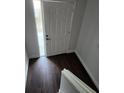 Inviting entryway featuring hardwood flooring, white front door, and crisp white trim at 500 New York Ave # 21, Dunedin, FL 34698