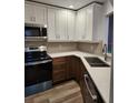 Modern kitchen features stainless steel appliances, white cabinetry, and gorgeous countertops at 500 New York Ave # 21, Dunedin, FL 34698