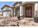 Close-up of the front entrance, featuring a red door, white pillars, and brick-paved driveway at 5001 44Th N Ave, St Petersburg, FL 33709