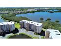 A high aerial shot showcases the condo building with a beautiful waterfront view from several angles at 6495 Shoreline Dr # 8105, Seminole, FL 33708