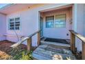 Front porch features a small wooden ramp, a covered entrance and nearby window at 805 Bruce Ave, Clearwater Beach, FL 33767