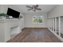 Living room featuring a fireplace, hardwood floors and natural light through the windows at 805 Bruce Ave, Clearwater Beach, FL 33767