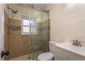 Tiled bathroom with a glass shower and modern fixtures at 8423 Jackson Springs Rd, Tampa, FL 33615