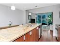 Granite kitchen island with stainless steel sink and dishwasher in an open living space at 111 N 12Th St # 1426, Tampa, FL 33602