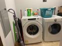 Laundry room with a white washer and dryer, shelving, and cleaning supplies at 111 N 12Th St # 1426, Tampa, FL 33602