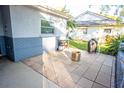 Tiled back patio featuring an outdoor grilling area and a fire pit at 13116 Sheridan Dr, Hudson, FL 34667