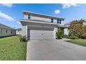 Charming two-story home featuring a well-maintained lawn, a two car garage, and neutral colors at 14153 Arbor Pines Dr, Riverview, FL 33579