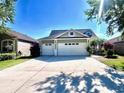 Charming single-story home with a three-car garage and a well-maintained lawn and landscape at 16313 Bridgecrossing Dr, Lithia, FL 33547