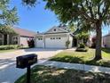 Charming single-story home with a three-car garage and a well-maintained lawn and landscape at 16313 Bridgecrossing Dr, Lithia, FL 33547