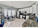 Bright kitchen with white cabinets, stainless steel appliances, and a cozy breakfast nook overlooking the water at 16313 Bridgecrossing Dr, Lithia, FL 33547