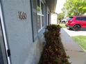Close up showing the house number on the side of the house with shrubs and colorful plants at 1660 Caledonia Dr, Palm Harbor, FL 34684