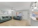 Inviting living room featuring comfortable seating, tile floors, ceiling fan, and plenty of natural light at 17035 Gulf Blvd # 202, North Redington Beach, FL 33708