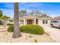 Inviting home featuring a double door entrance, meticulous landscaping, and a driveway with ample parking at 2490 E Vina Del Mar Blvd, St Pete Beach, FL 33706