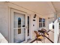 Close-up of the front porch area with seating near the front door at 2533 Limewood Dr, Holiday, FL 34690