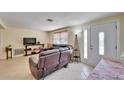 Living room with tile flooring, a large sofa, and lots of natural light at 2533 Limewood Dr, Holiday, FL 34690