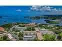 Beautiful aerial view of community, showcasing lush landscaping, inviting pool, and waterfront access at 2700 Bayshore Blvd # 588, Dunedin, FL 34698