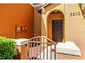 Exterior door with an arched doorway and small gate leading to the entrance at 30103 Mossbank Dr, Wesley Chapel, FL 33543