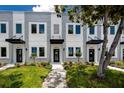 Charming townhome exterior with well-kept landscaping and a paved walkway to the inviting front entrance at 3402 E 28Th Ave # 4, Tampa, FL 33605