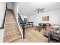 Bright, open-concept living space with staircase and stylish furniture flowing into the kitchen with counter seating at 3402 E 28Th Ave # 4, Tampa, FL 33605