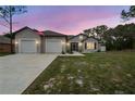 Charming single-story home with a three car garage and well-manicured front lawn at 4307 Dristol Ave, Spring Hill, FL 34609