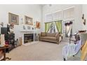 Bright living room featuring a fireplace, large windows, and neutral decor at 5167 Sterling Manor Dr, Tampa, FL 33647