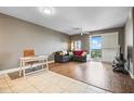 Open living room featuring a work space, hardwood floors, neutral tones, and a sliding door to a balcony with a view at 628 Cleveland St # 1208, Clearwater, FL 33755