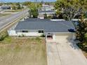 Single-story home with paved driveway and a nicely-sized yard at 7205 Mayfield Dr, Port Richey, FL 34668