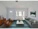 Bright and airy living room featuring a picture window, modern furnishings, and sleek wood flooring at 807 Nectar Rd, Venice, FL 34293