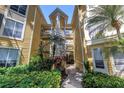 Charming condo building with vibrant landscaping and a welcoming walkway at 115 112Th Ne Ave # 310, St Petersburg, FL 33716