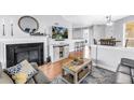 Cozy living room featuring a fireplace, modern decor, and hardwood floors at 115 112Th Ne Ave # 310, St Petersburg, FL 33716