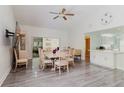 Bright dining area with wood floors and open access to the kitchen, living areas, and lanai at 11521 Rose Tree Dr, New Port Richey, FL 34654