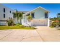 Charming two-story home with a two-car garage, white trim, well-maintained lawn, and inviting front entrance at 118 Wall St, Redington Shores, FL 33708